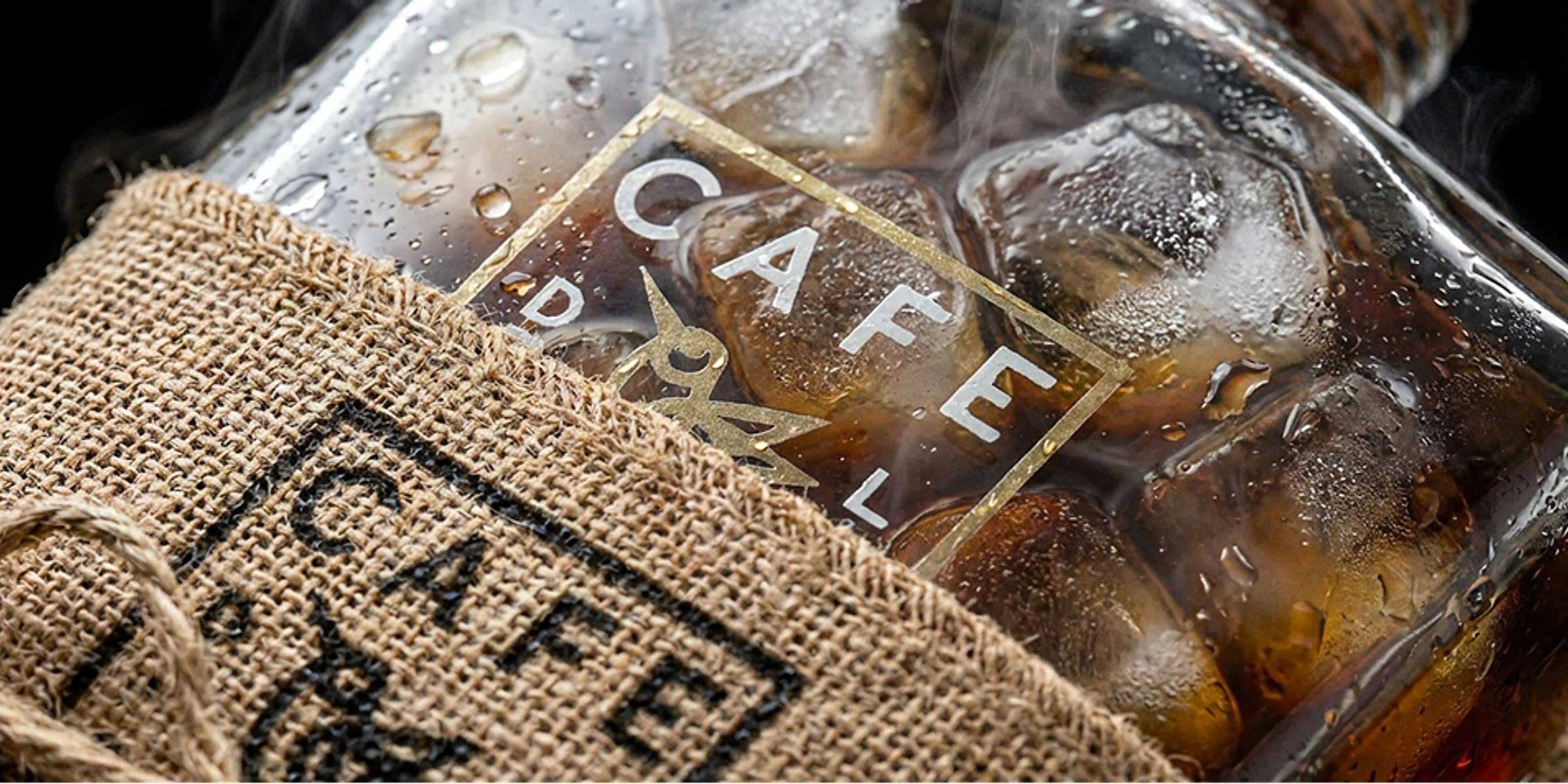 Café De La Corte bottle with the original transparent shield label and hand-tied burlap sleeve